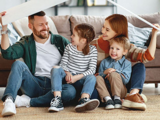 concept housing a young family. mother father and children in new home