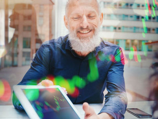 Businessman shows trading stock market chart on a tablet