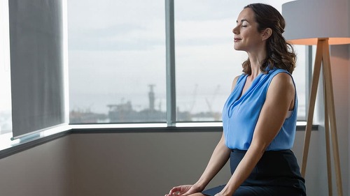 Executive meditating on fitness ball