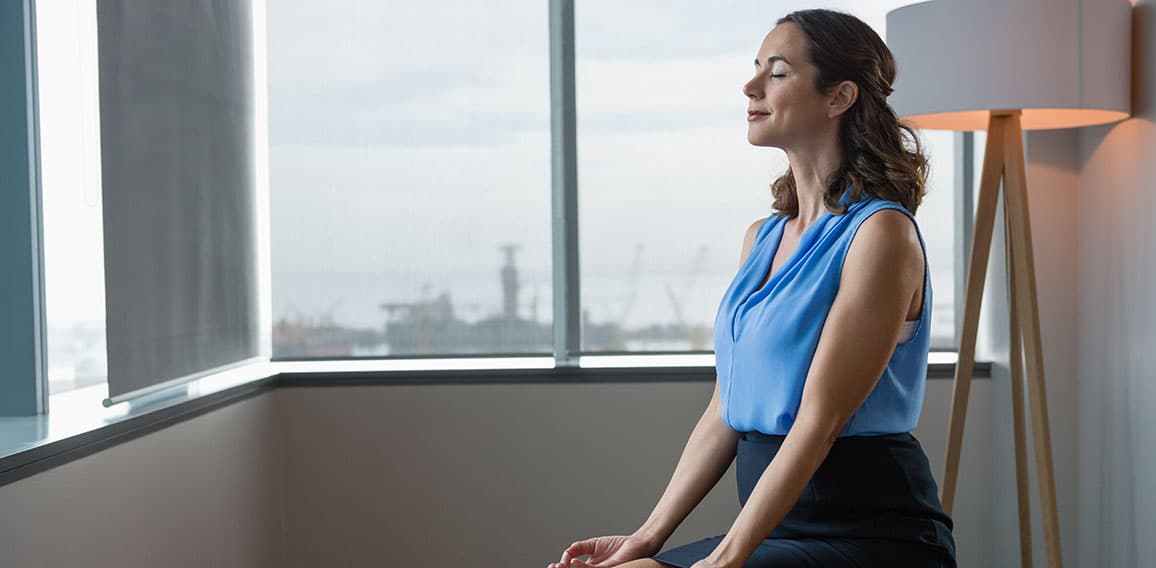 Executive meditating on fitness ball