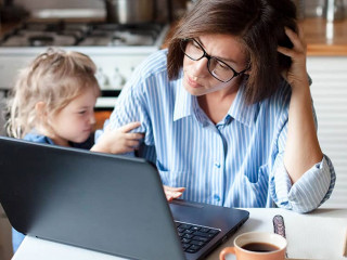 Working mother in home office. Unhappy woman and child using laptop. Sad and angry daughter