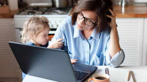 Working mother in home office. Unhappy woman and child using laptop. Sad and angry daughter