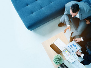 Top view, two businessmen sitting in the office talking about ma