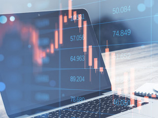 Close up of laptop with abstract falling candlestick forex chart on blurry background. Crisis, workplace and stock concept. Double exposure.