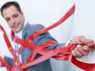 Businessman trapped by red tape