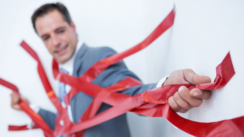 Businessman trapped by red tape