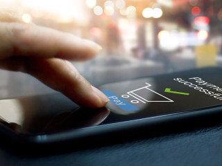 Hand touching mobile screen of a Payment successful message on s