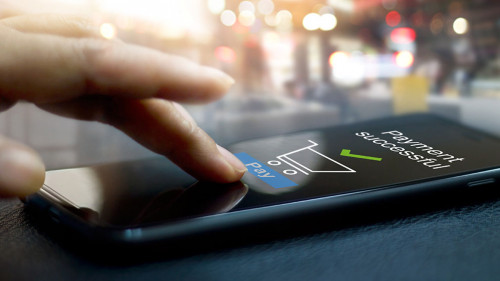 Hand touching mobile screen of a Payment successful message on s