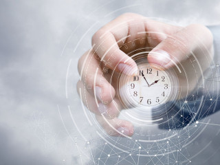 Hand of a businessman in the sky shows the clock .