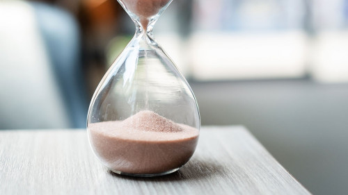 Hourglass on table office with copy space, Sand flowing through