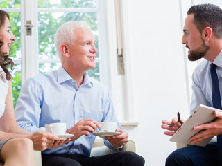 Financial advisor consulting couple in retirement planning