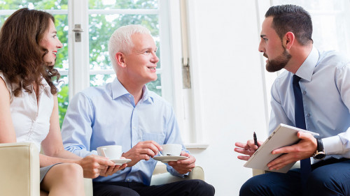 Financial advisor consulting couple in retirement planning