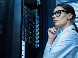 Professional young woman working in a data center
