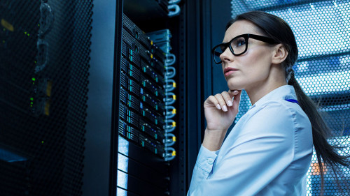 Professional young woman working in a data center