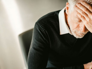 Stressed businessman sitting in office