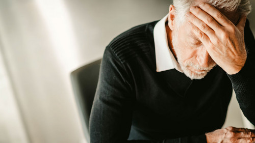 Stressed businessman sitting in office