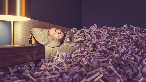 Mann-Bett-Geldscheine-466685046-AS-tiero