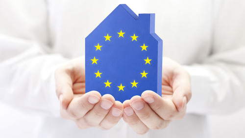 House with European Union flag in hands