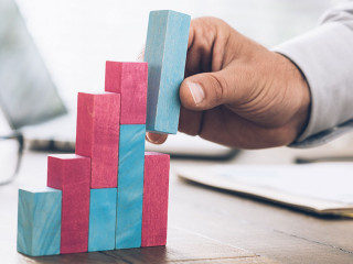 Businessman building a successful financial graph