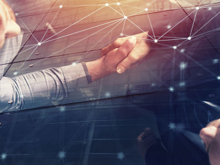 Handshaking business person in office with network effect. concept of teamwork and partnership. double exposure