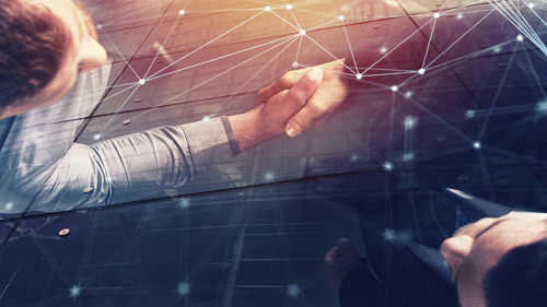 Handshaking business person in office with network effect. concept of teamwork and partnership. double exposure