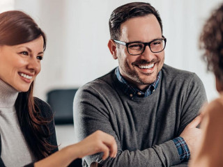 Happy couple talking with sales manager