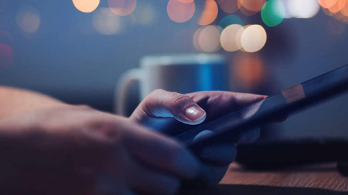 Woman reading online news on digital tablet
