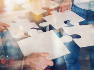 Teamwork of partners connect puzzle pieces as integration and startup