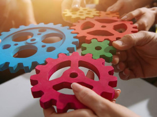 Business team connect pieces of gears. Teamwork, partnership and integration concept