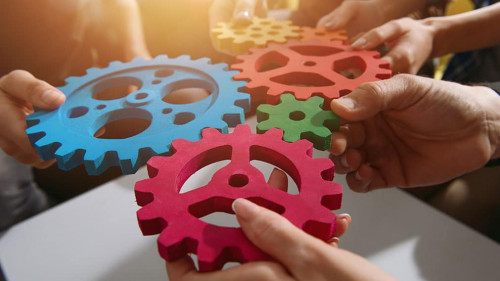 Business team connect pieces of gears. Teamwork, partnership and integration concept