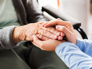 Unrecognizable health visitor and a senior woman during home vis