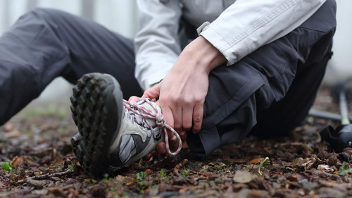 Trekker complaining alone in the mountain with broken ankle