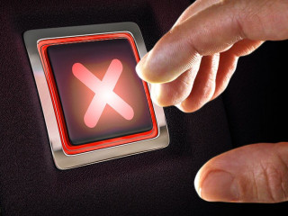 Finger about to press cross button. Mixed media