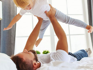 happy family father and child son at home in bed