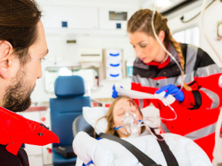Ambulance helping injured woman with infusion