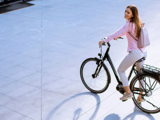 Young woman with modern city electric e-bike clean sustainable u