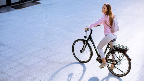 Young woman with modern city electric e-bike clean sustainable u
