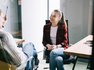 Cheerful office workers talking behind glass door