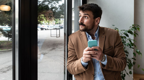 Young business man waiting for the taxi or cab that he called or