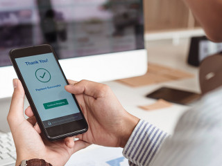 Man's hands holding smartphone and successful online payment. Mobile wallet payment concept.