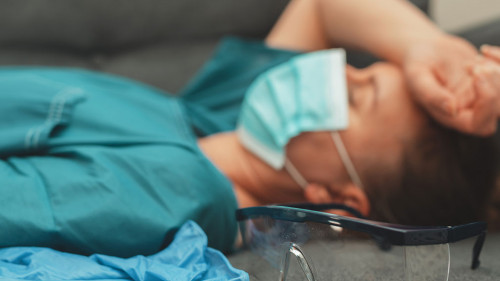 Tired medical worker after a shift. Burnout at work.