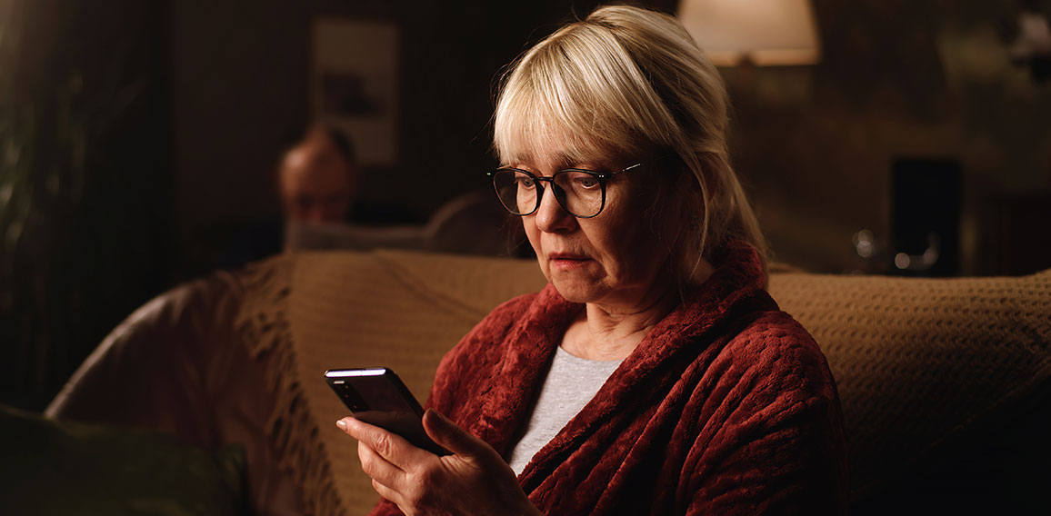 Scared aged woman reading shocking news