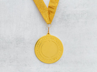 Gold medal first place on ribbon. Winner or champion trophy