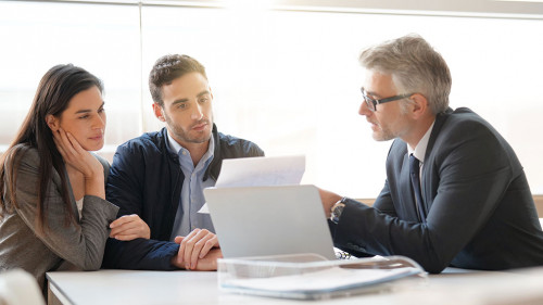 Young couple meeting financial advisor for home investment
