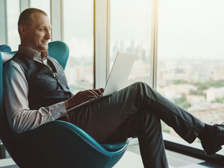 A businessman is using a laptop