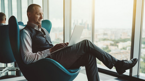 A businessman is using a laptop