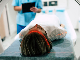Young woman patient is ready to do magnetic resonance imaging in
