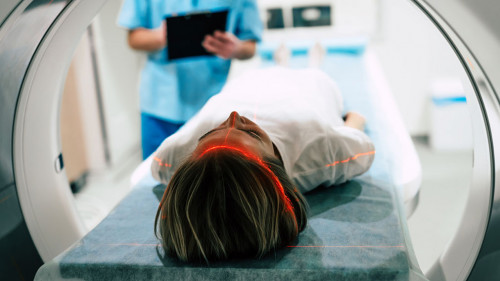 Young woman patient is ready to do magnetic resonance imaging in