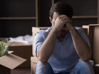 Sad desperate depressed homeowner, renter man leaving out from apartment