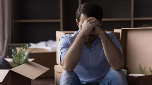 Sad desperate depressed homeowner, renter man leaving out from apartment